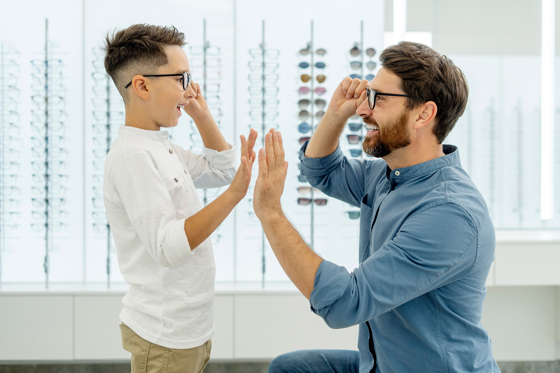Man and boy trying on eyeglasses